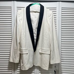 Off white tuxedo style jacket with black satin collar. Never been worn.